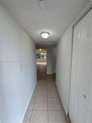 a view of a hallway with wooden shelves