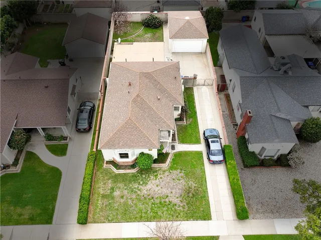 an aerial view of a house with a yard
