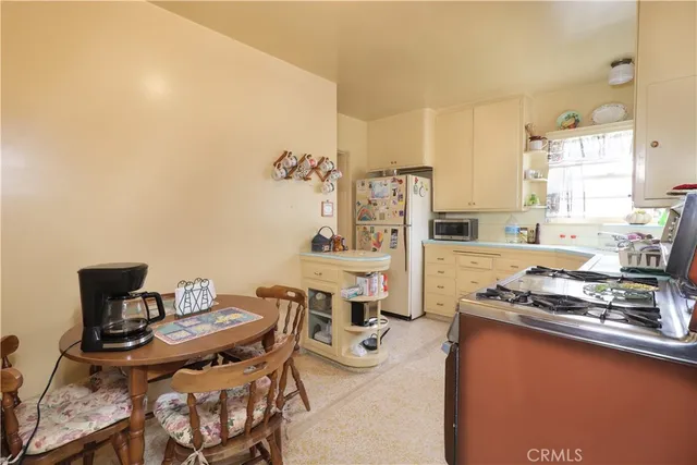 a kitchen with a table and chairs