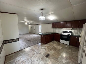 3845 Wickham Road Palmyra, TN 37142 - Photo 5 of 12 a kitchen with stainless steel appliances granite countertop a refrigerator a stove and a sink with cabinets