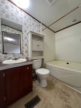 3845 Wickham Road Palmyra, TN 37142 - Photo 6 of 12 a bathroom with a double vanity sink mirror and toilet
