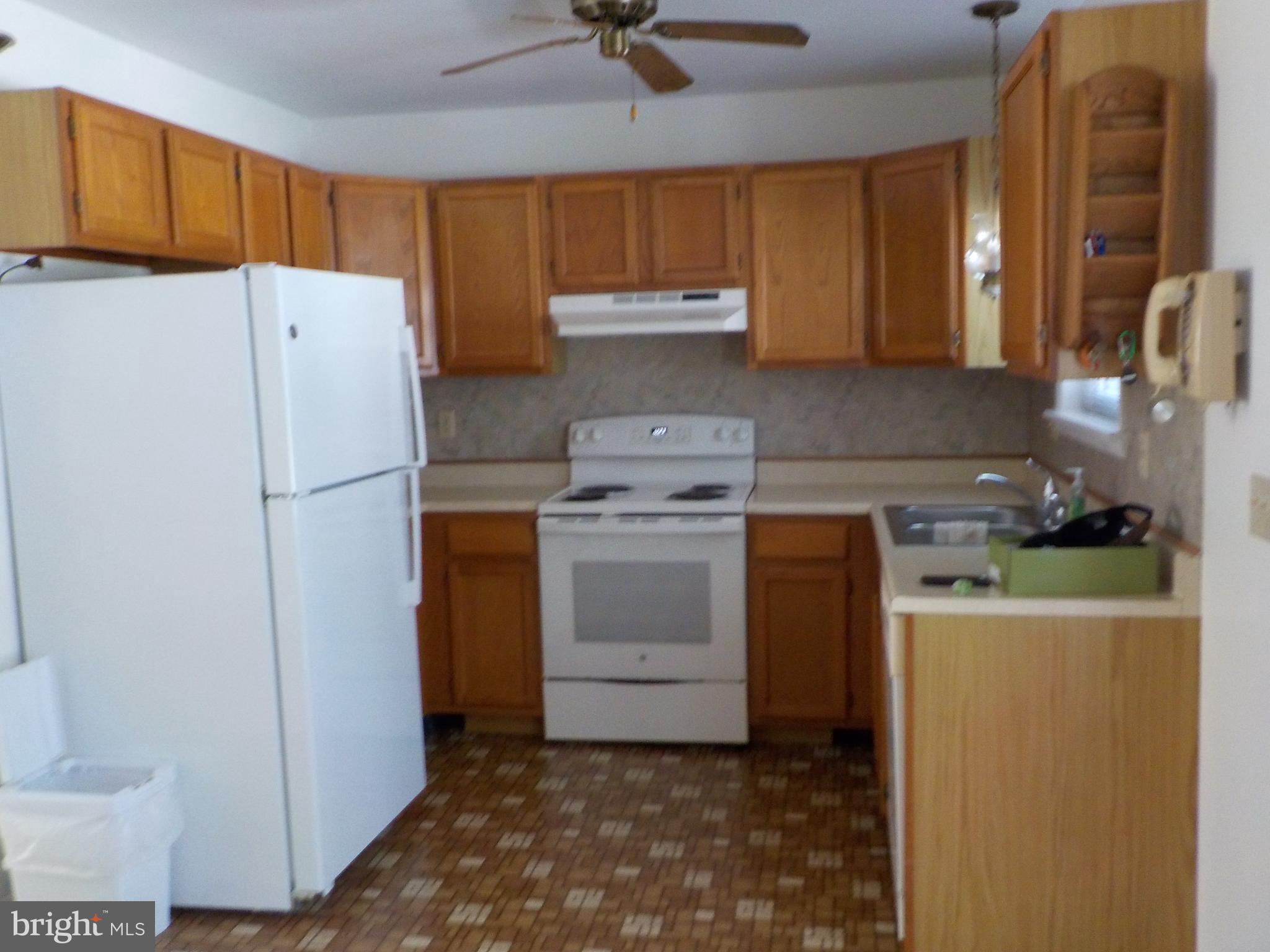 4 Justin Court Lititz, PA 17543 - Photo 10 of 14 a kitchen with a refrigerator a stove a washer dryer and cabinets