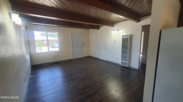 a view of an empty room and wooden floor