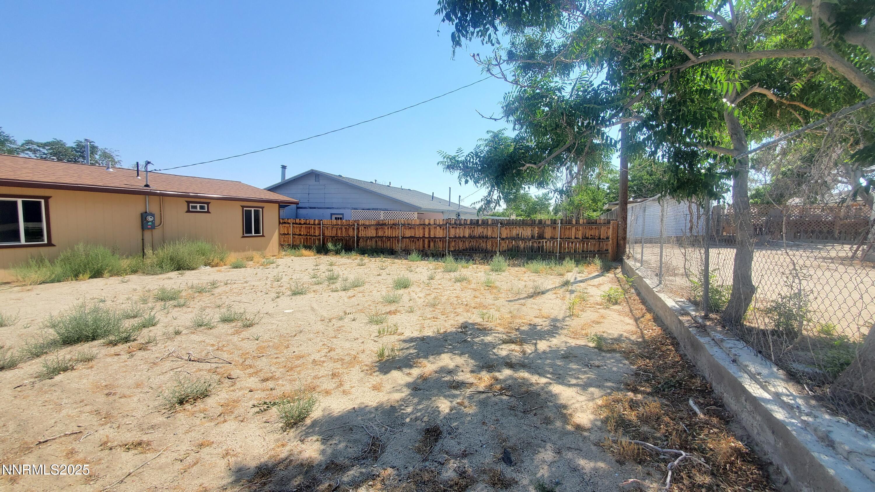122 Harrison Street Hawthorne, NV 89415 - Photo 12 of 18 a view of a yard with a house in the background