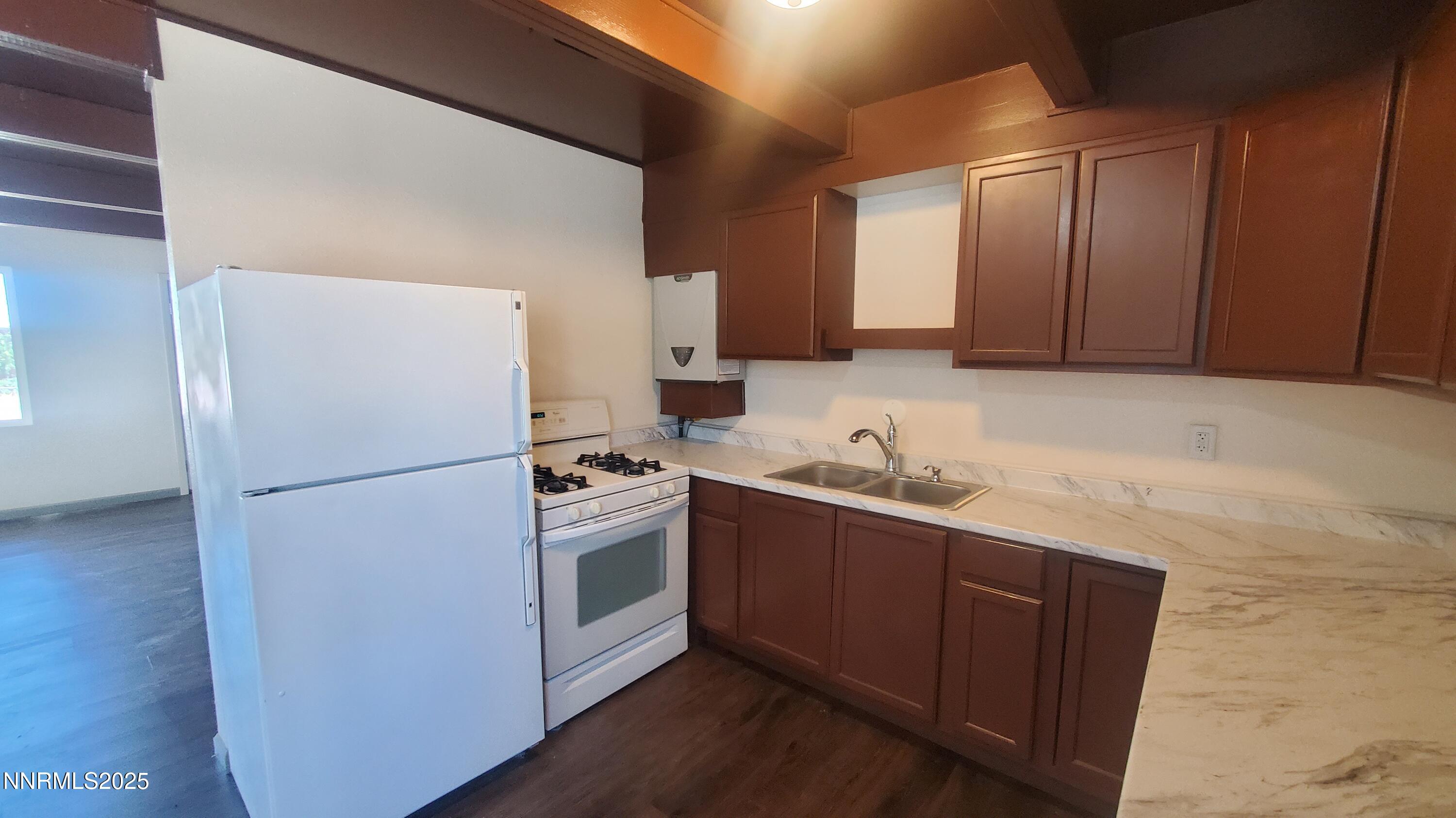 122 Harrison Street Hawthorne, NV 89415 - Photo 15 of 18 a kitchen with stainless steel appliances granite countertop a refrigerator a sink and a stove
