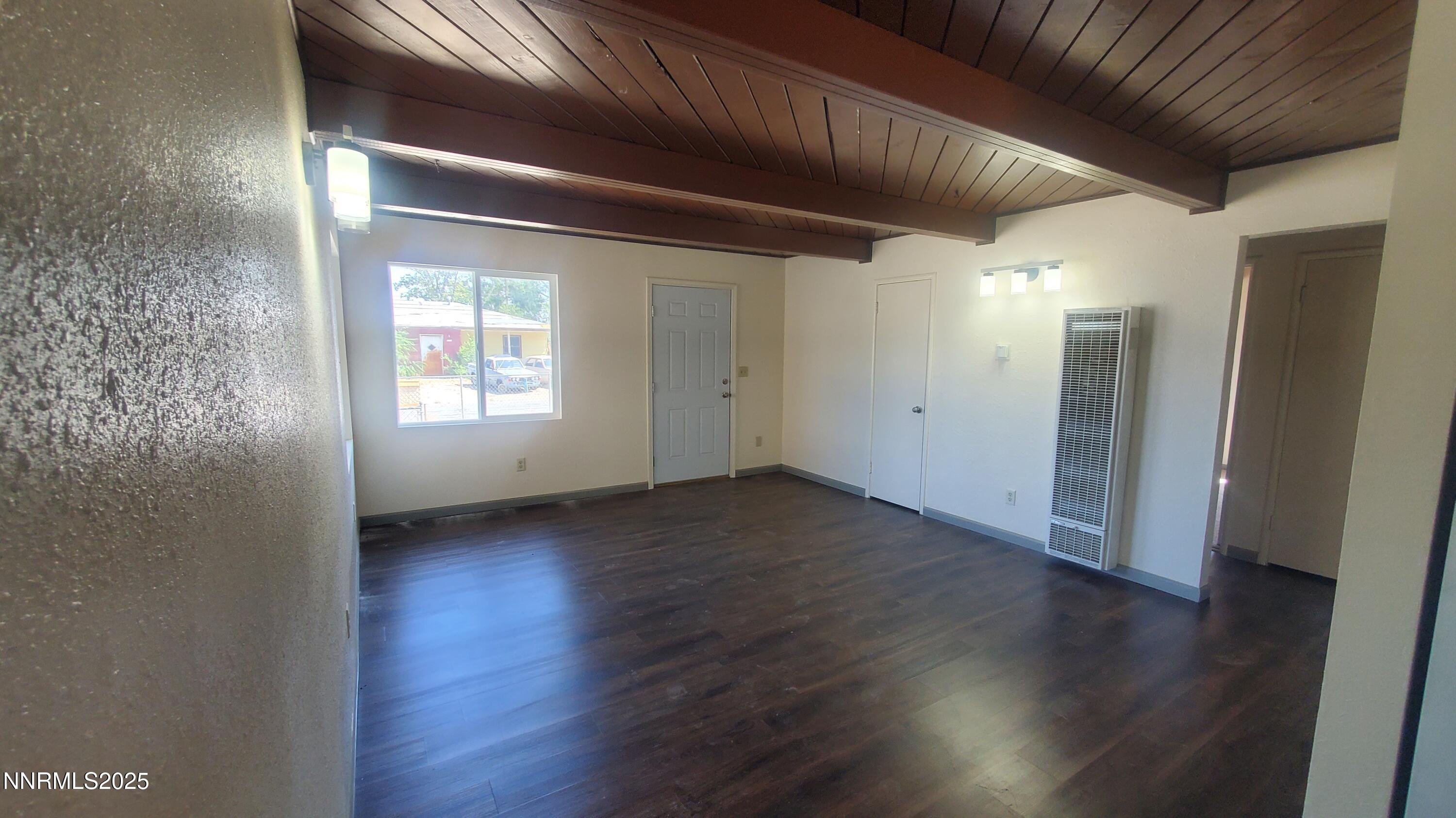 122 Harrison Street Hawthorne, NV 89415 - Photo 17 of 18 an empty room with wooden floor and windows