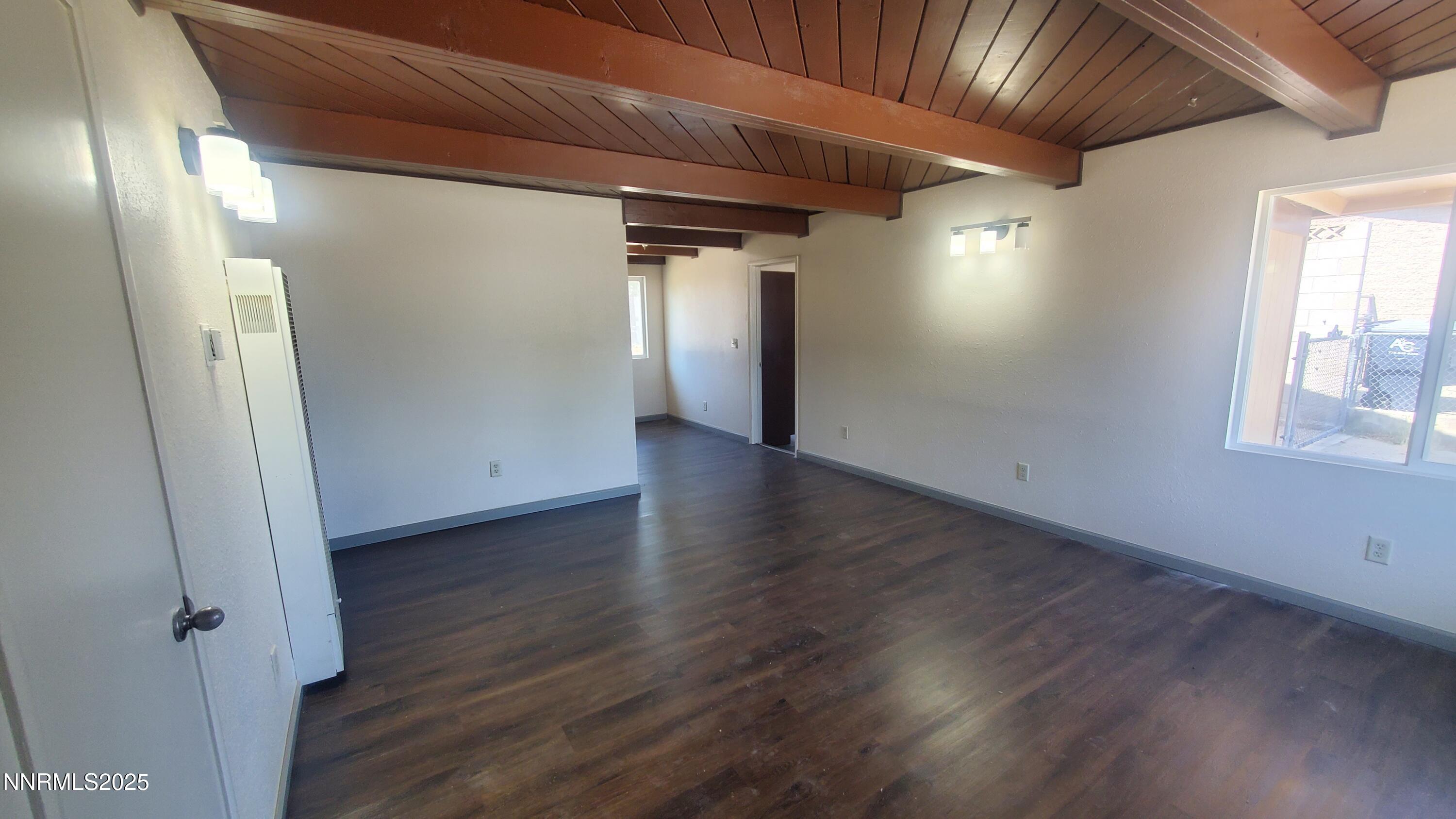 122 Harrison Street Hawthorne, NV 89415 - Photo 18 of 18 an empty room with wooden floor and windows