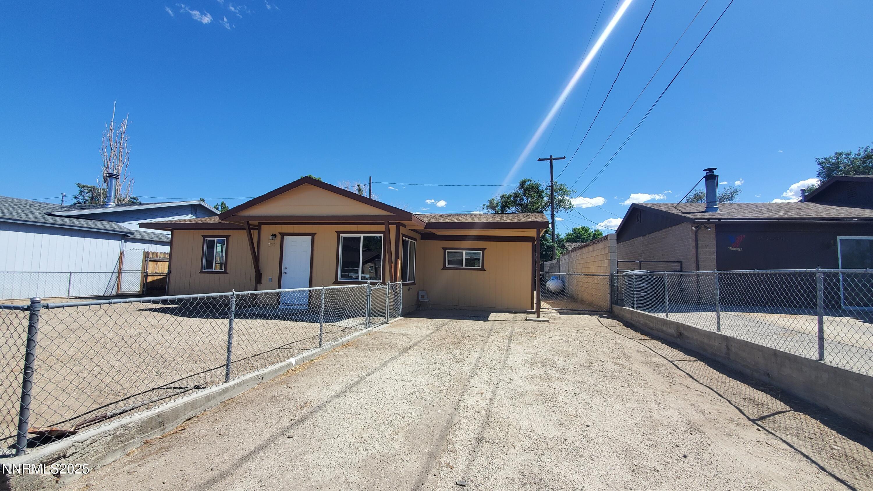 122 Harrison Street Hawthorne, NV 89415 - Photo 2 of 18 a front view of a house with a yard