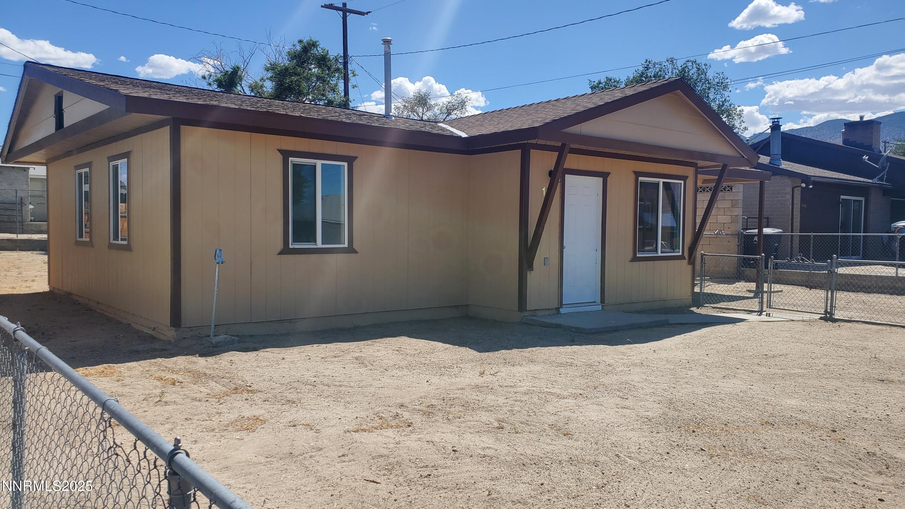 122 Harrison Street Hawthorne, NV 89415 - Photo 3 of 18 a bedroom with a bed and a chandelier