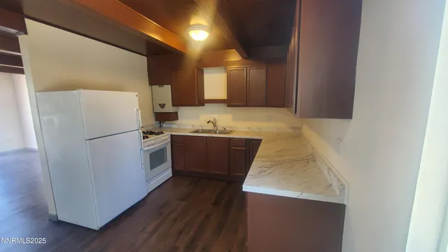 a kitchen with stainless steel appliances a refrigerator a sink and a stove