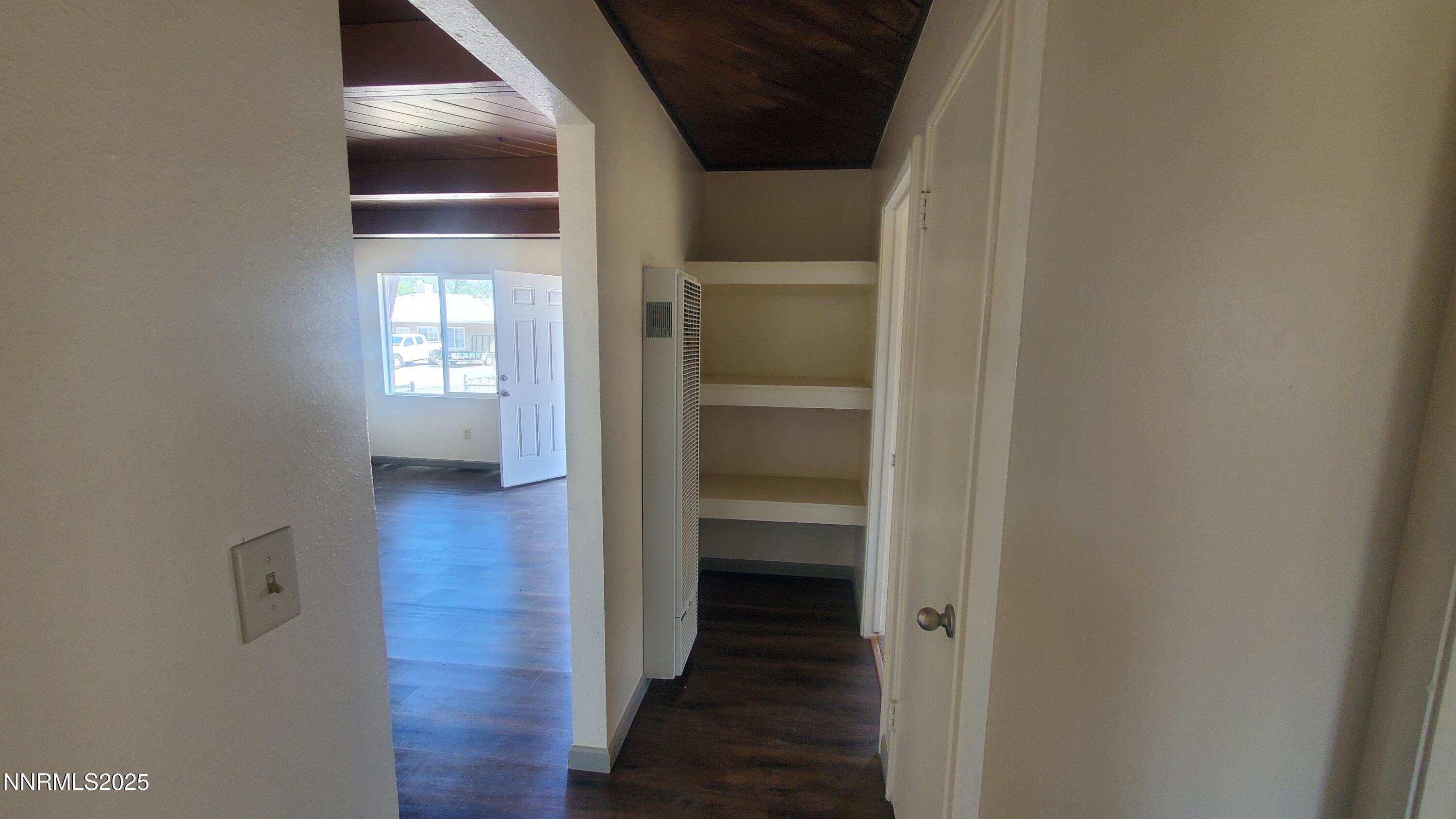 122 Harrison Street Hawthorne, NV 89415 - Photo 10 of 18 a view of a hallway with wooden floor and a bathroom