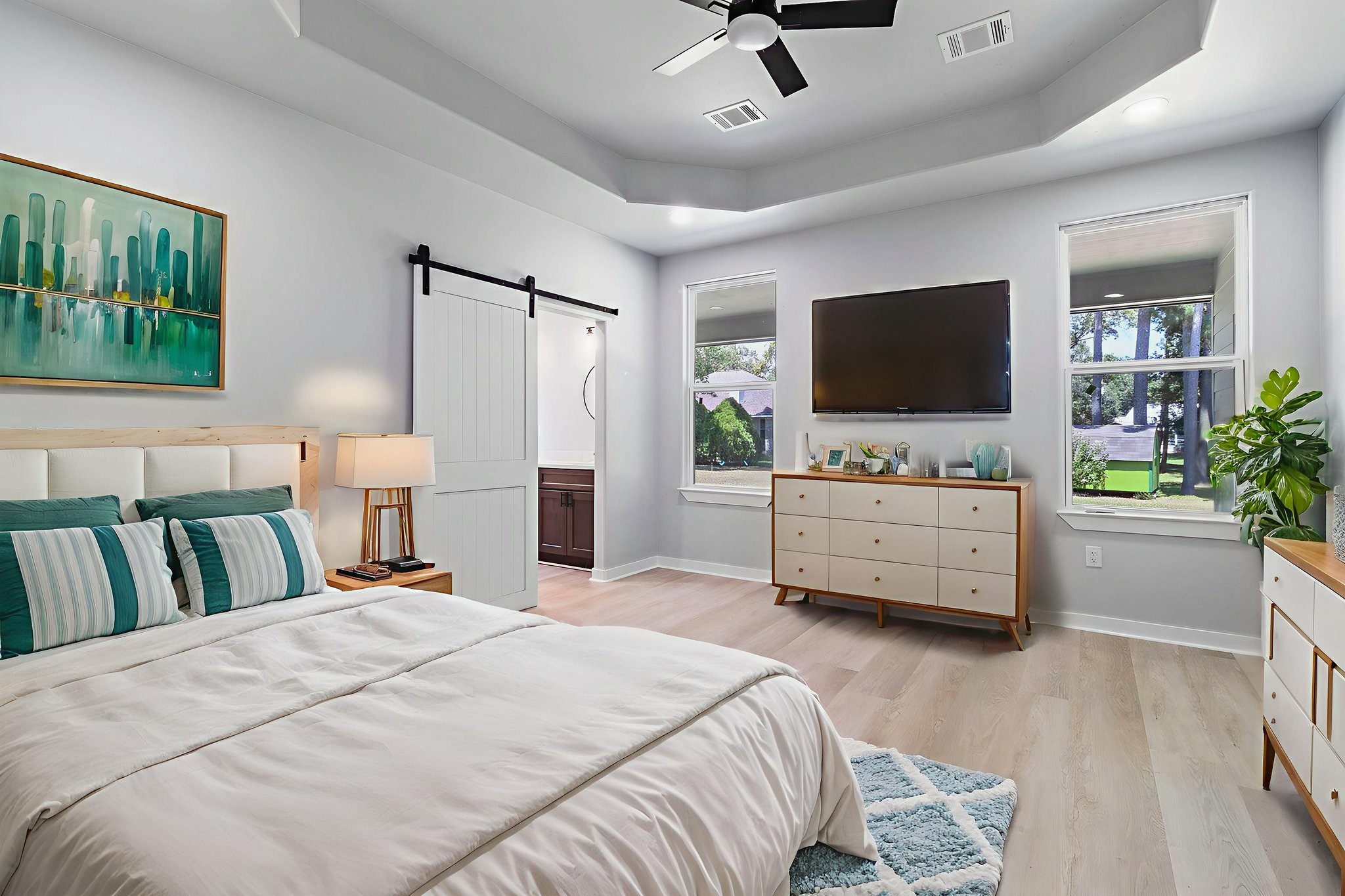 599 Bridgeview Drive Onalaska, TX 77360 - Photo 21 of 27 a bedroom with a bed a flat screen tv and a couch