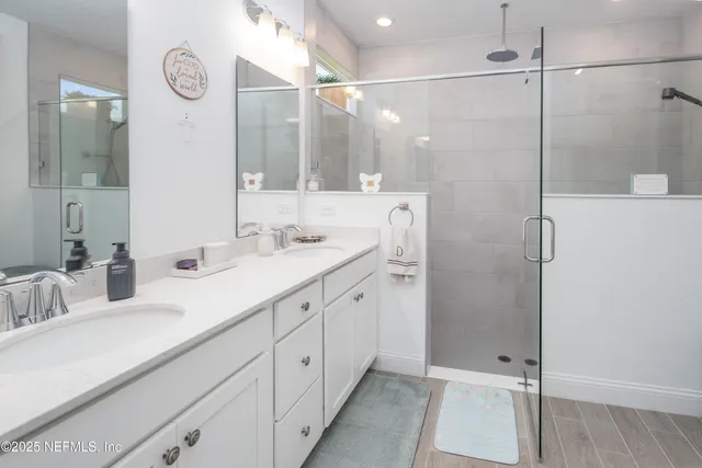 a bedroom with a bed and a lamp on the dresser