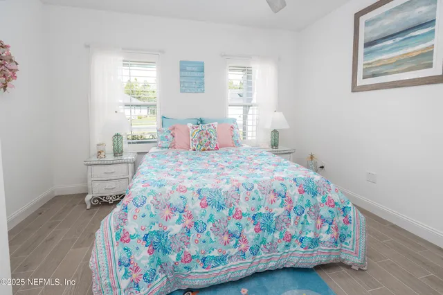 a view of balcony with chairs and floor to ceiling window next to a yard