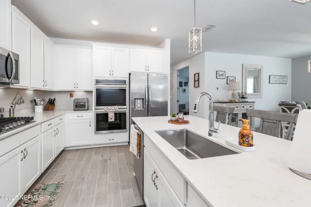 a kitchen with a sink stove and refrigerator