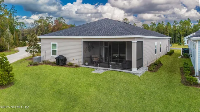 a view of a house with a yard and sitting area