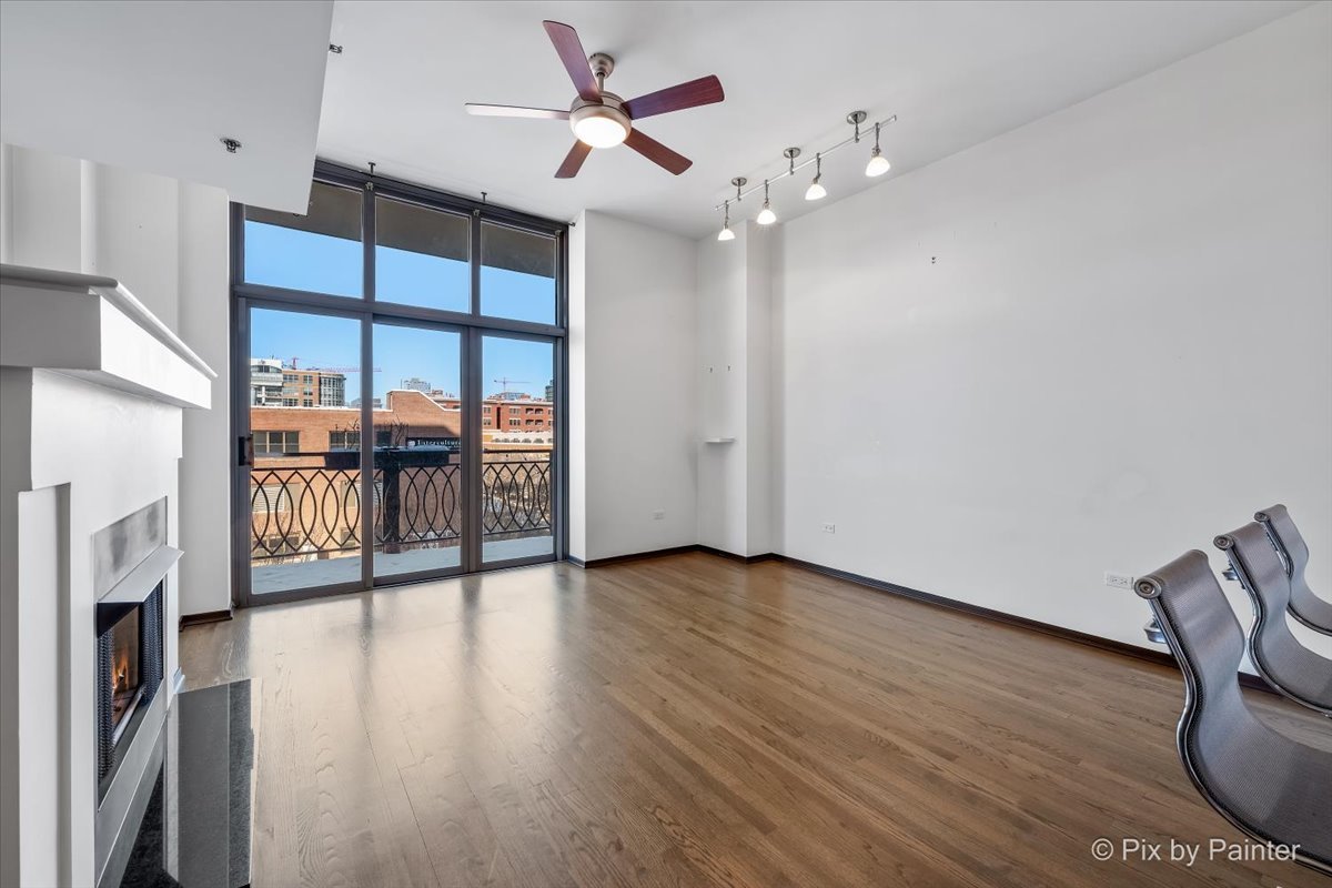 1201 West Adams Street, Unit 403 Chicago, IL 60607 - Photo 11 of 28 a view of an empty room with wooden floor and a window