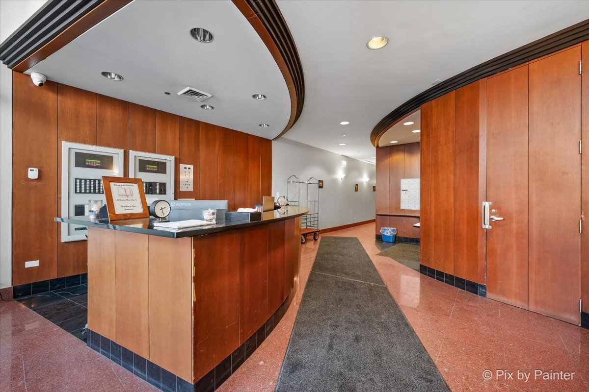 1201 West Adams Street, Unit 403 Chicago, IL 60607 - Photo 26 of 28 a kitchen with stainless steel appliances granite countertop a refrigerator a sink a stove and wooden floors