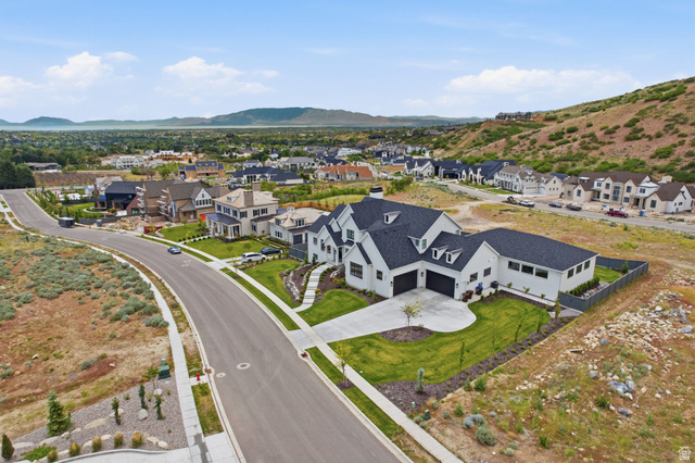 1817 North Dean Court, Unit 12 Alpine, UT 84004 - Photo 37 of 38 Modern farmhouse architecture featuring a crisp white exterior, dark pitched roofs, and multiple dormer windows
