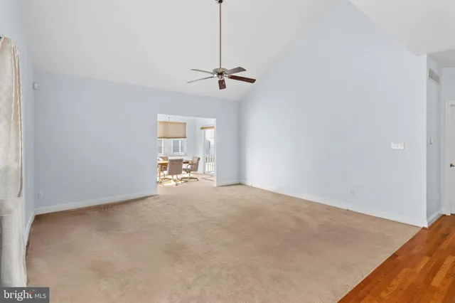 an empty room with a empty space and a ceiling fan
