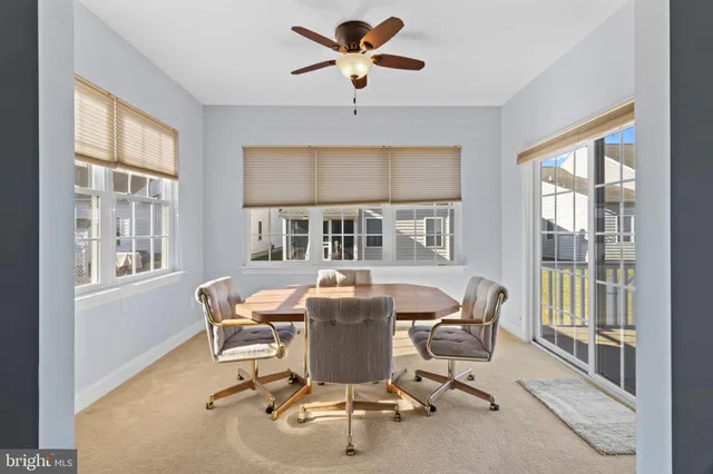 a dining room with furniture a chandelier and window