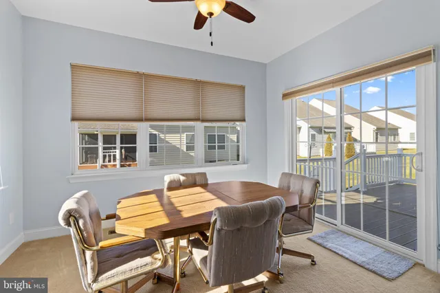 a dining room with furniture a chandelier and wooden floor