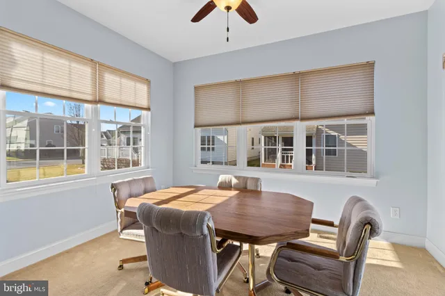 a dining room with furniture and window