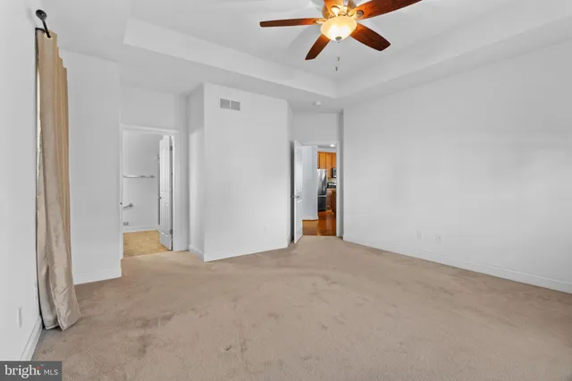 a view of an empty room with a ceiling fan