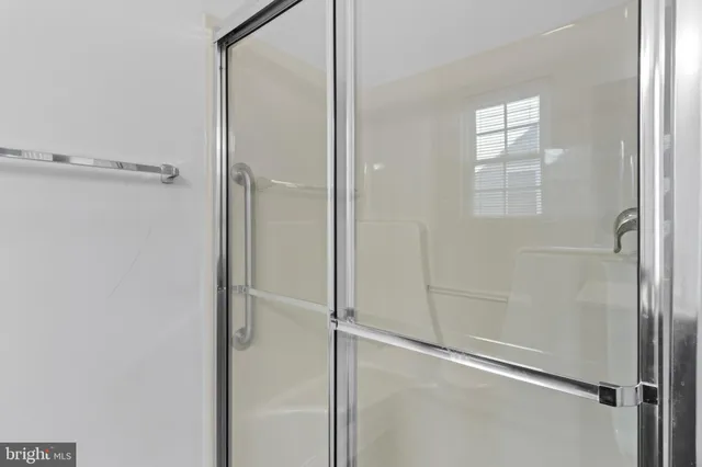 a bathroom with a glass shower door