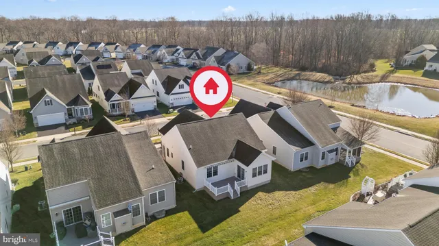 an aerial view of a house with a yard and lake view