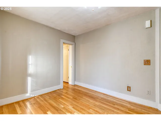 a view of an empty room and wooden floor
