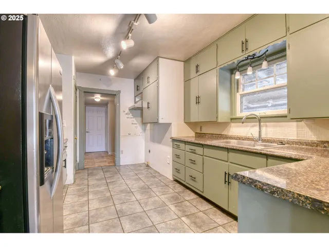 a bathroom with a granite countertop sink mirror and a shower