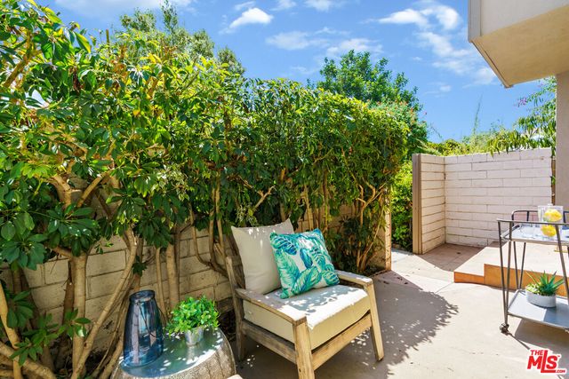 an outdoor space with furniture and garden