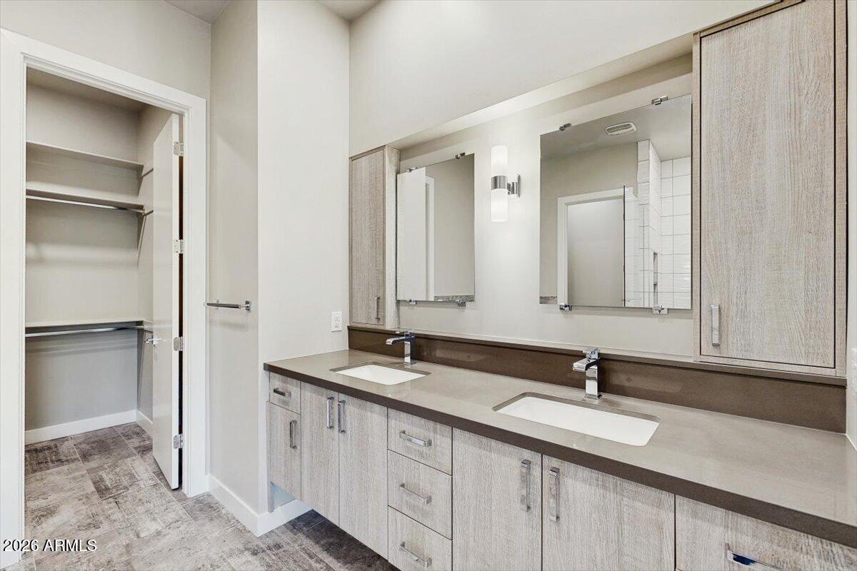 2645 East Osborn Road, Unit 3 Phoenix, AZ 85016 - Photo 8 of 14 a bathroom with a granite countertop sink and a mirror