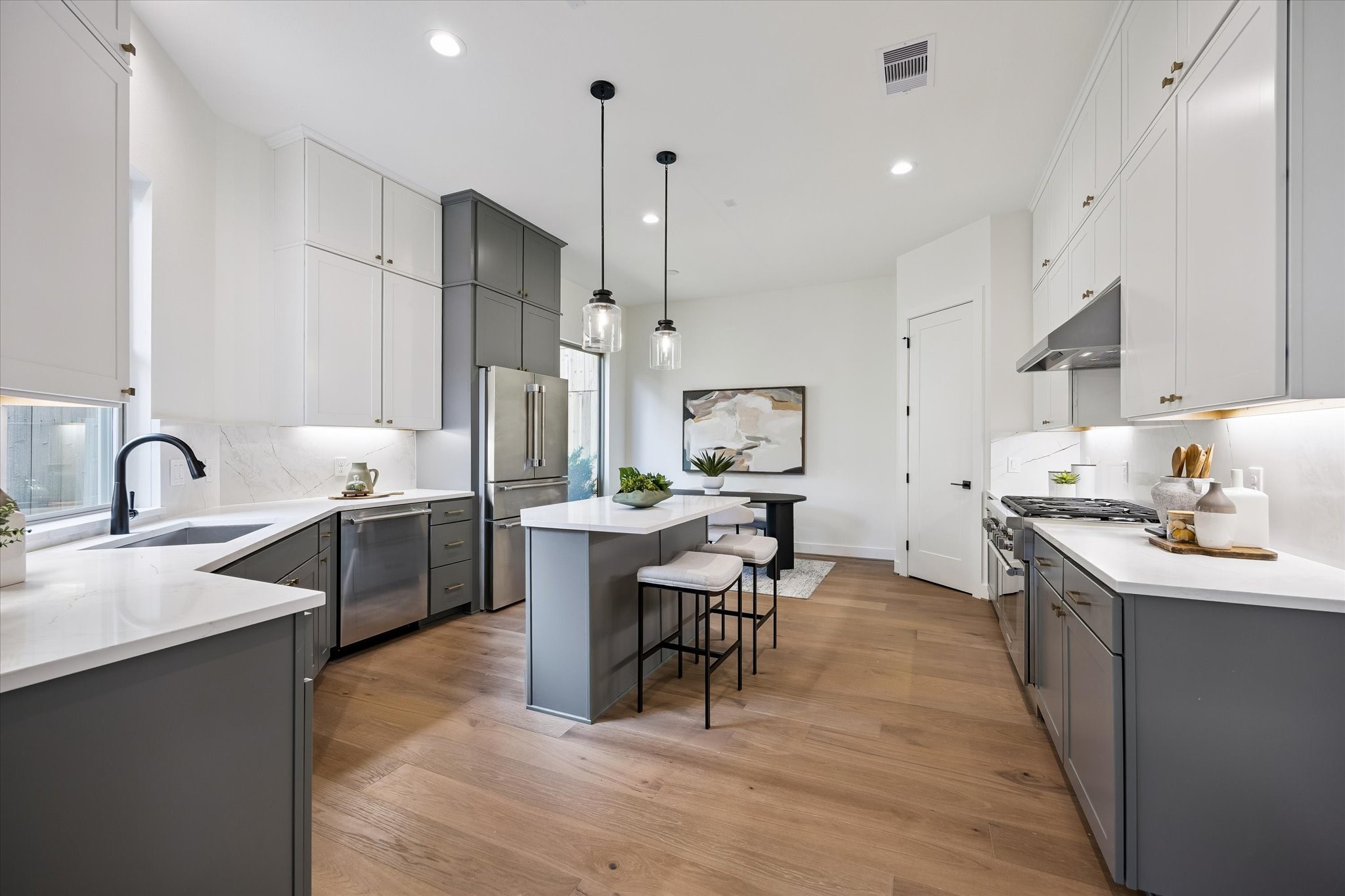 5329 Dora Street Houston, TX 77005 - Photo 11 of 43 This stunning open-concept gourmet kitchen is perfect for entertaining, featuring top-tier Thermador appliances, including a professional six-burner stove. A center island offers dining and prep space, while a large picture window bathes the space in natural light.