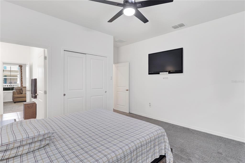 7185 Southwest 63rd Street Ocala, FL 34474 - Photo 21 of 31 a bedroom with a bed and a flat screen tv