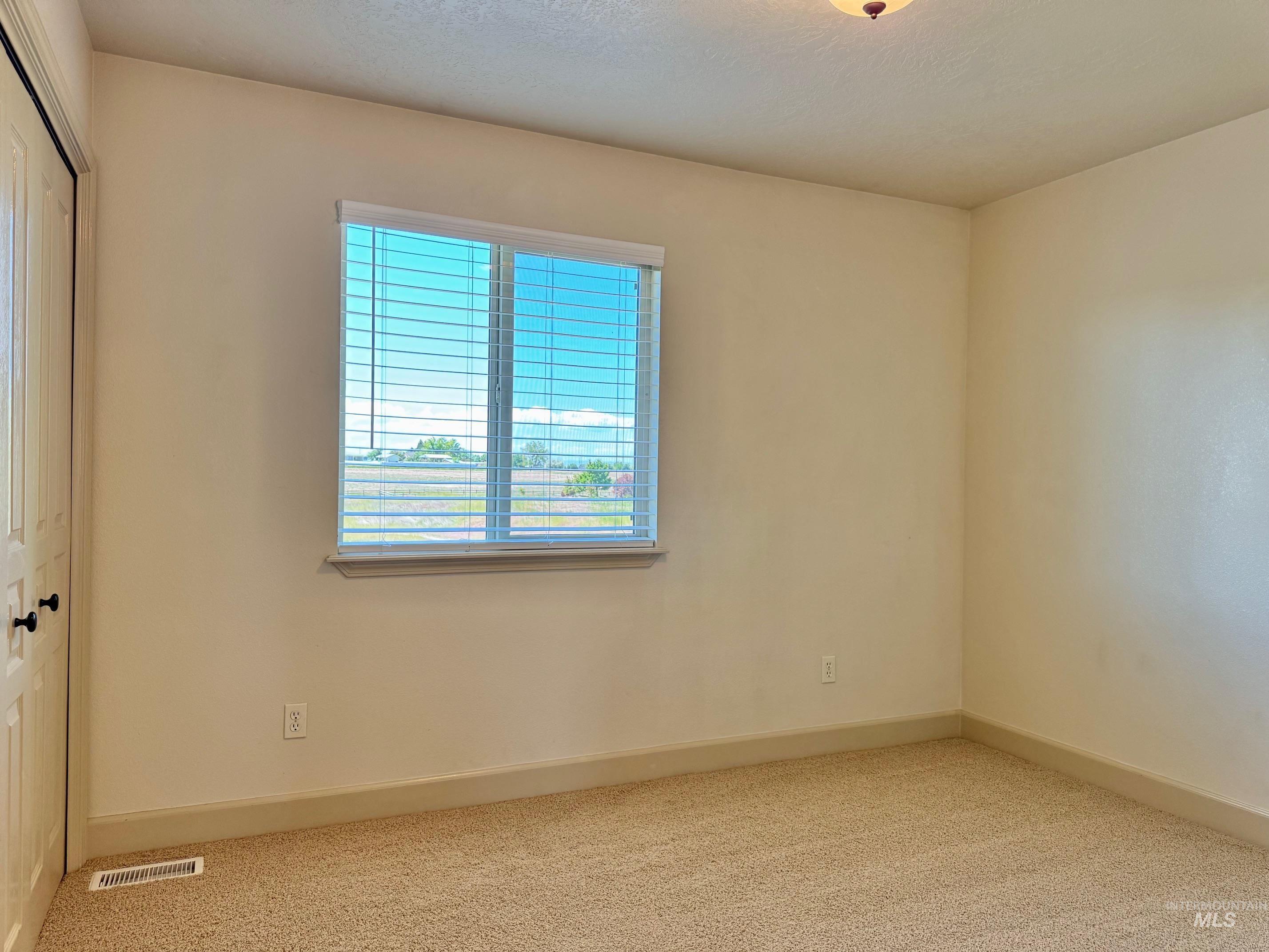 9299 Kemp Road Middleton, ID 83644 - Photo 32 of 50 Neutral-toned carpeting complements the light-colored walls and baseboards
