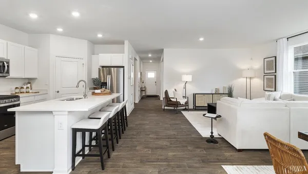 a large kitchen with a table and chairs