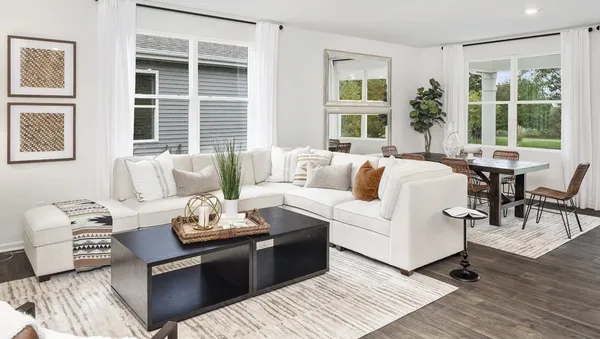 a living room with furniture and large windows