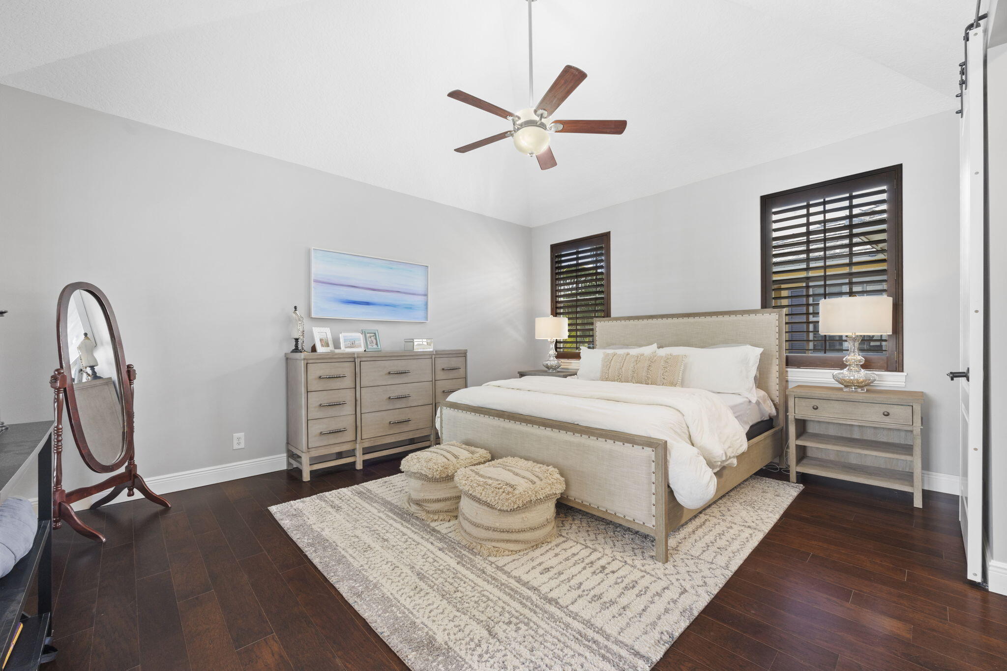 202 Botanica Drive Jupiter, FL 33458 - Photo 16 of 33 a bedroom with a bed and dresser with wooden floor