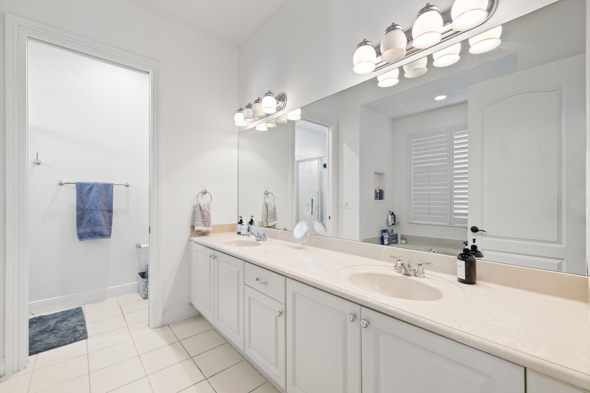 202 Botanica Drive Jupiter, FL 33458 - Photo 24 of 33 a bathroom with a sink double vanity and a mirror