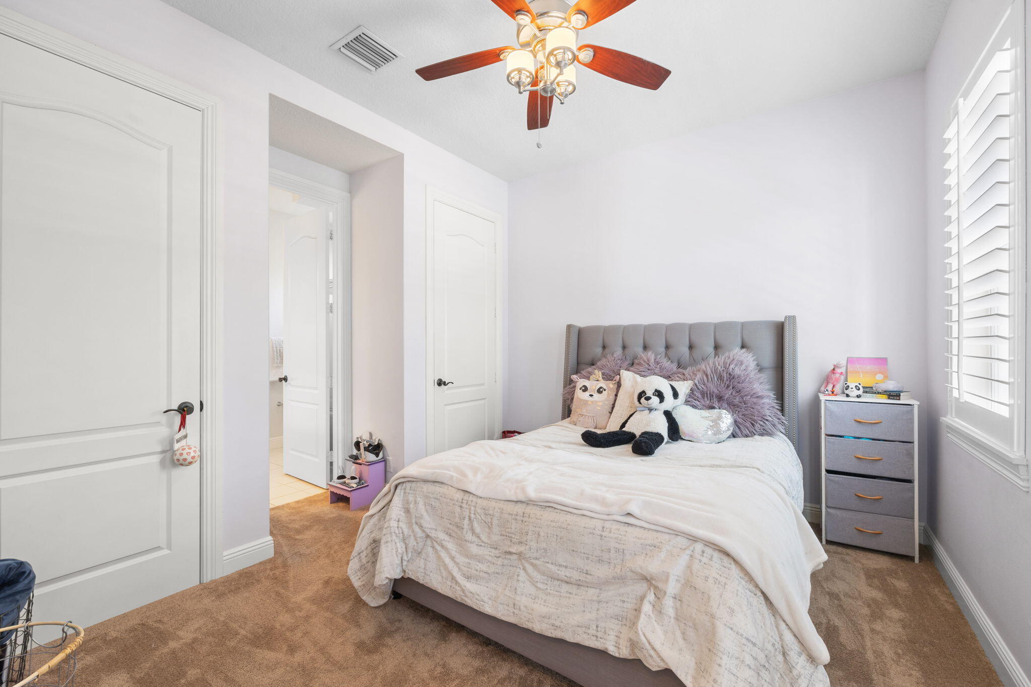 202 Botanica Drive Jupiter, FL 33458 - Photo 25 of 33 a bedroom with a bed and a chandelier