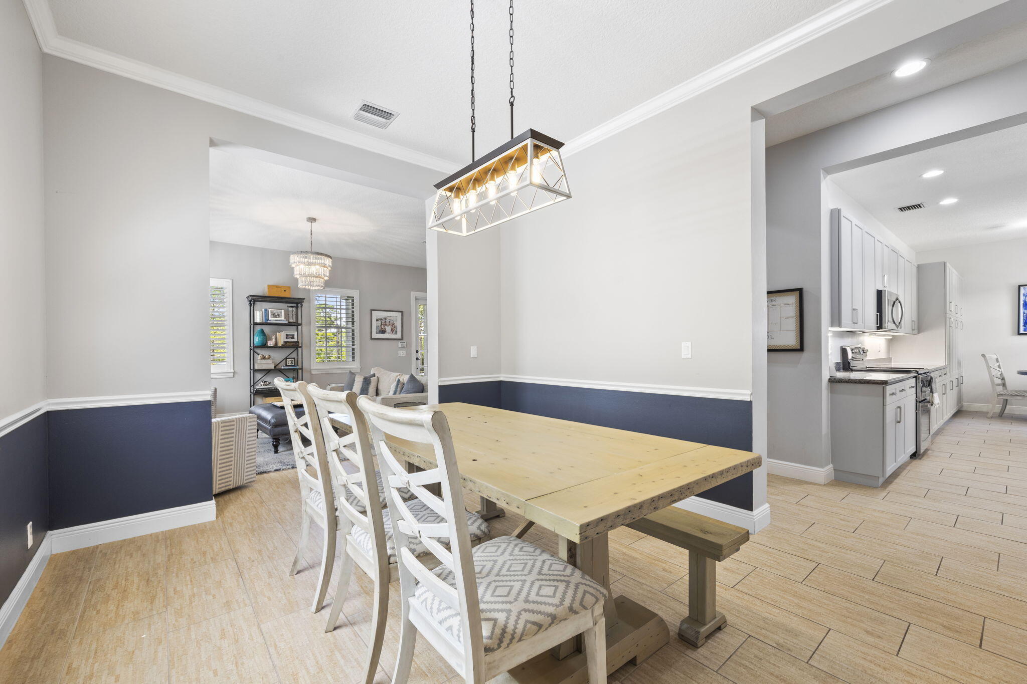 202 Botanica Drive Jupiter, FL 33458 - Photo 9 of 33 a view of a dining room with furniture and wooden floor