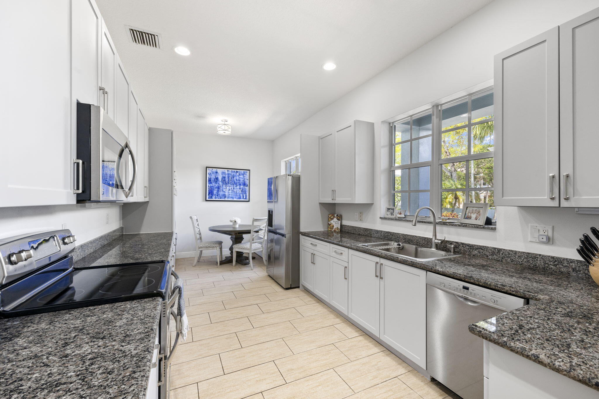 202 Botanica Drive Jupiter, FL 33458 - Photo 10 of 33 a large kitchen with stainless steel appliances granite countertop a sink and a counter space