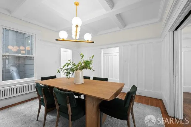 a view of a dining room with a table and chairs