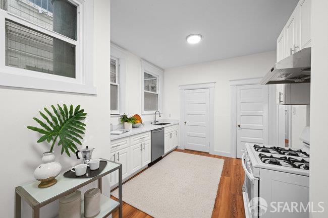1108-1112 Pine Street San Francisco, CA 94109 - Photo 19 of 53 a kitchen with a refrigerator and a stove