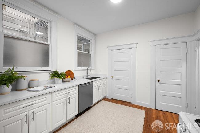 1108-1112 Pine Street San Francisco, CA 94109 - Photo 20 of 53 a kitchen with a sink and cabinets
