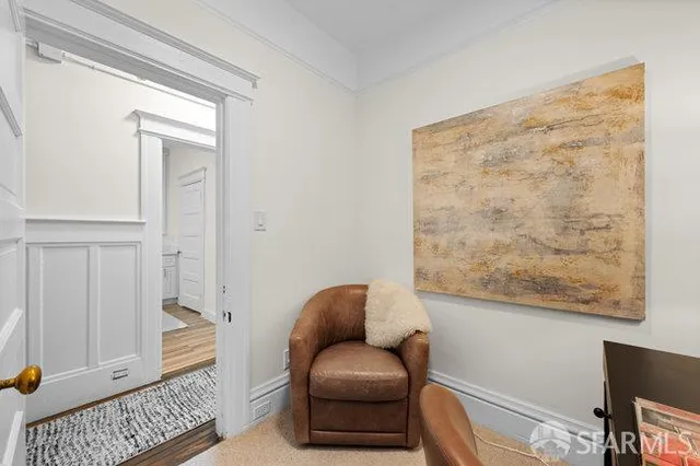 a hallway with a couch and a window with chair