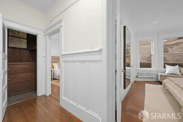 a view of a bedroom with cabinet and door