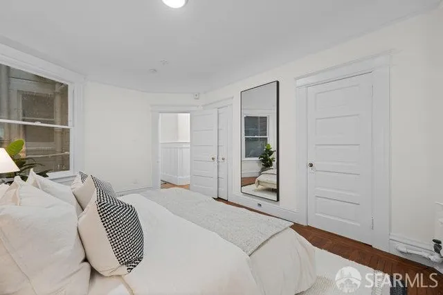 a bedroom with a bed and a window